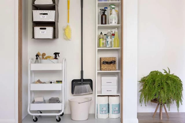 Organized cleaning supply closet with labeled bins and child-safe chemical storage for home poison prevention