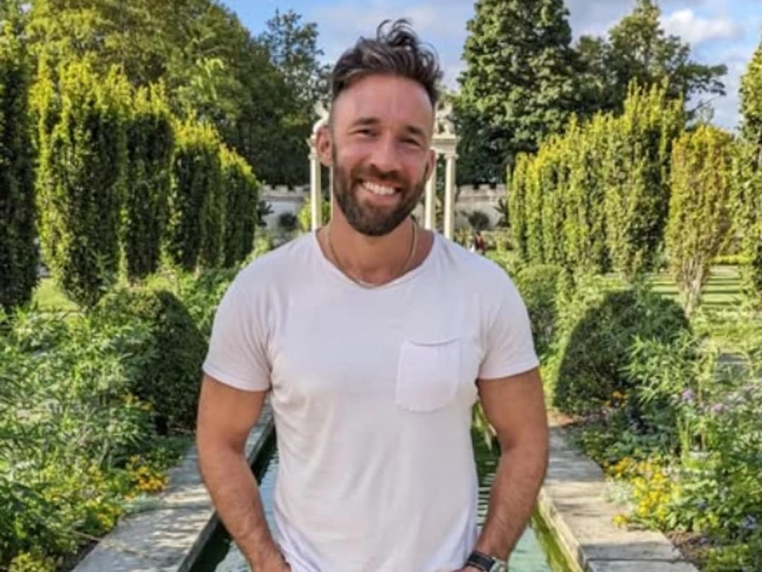Tyler Wall, MrBeast's fitness coach, smiling in a garden before his tragic death from mitragynine toxicity linked to kratom overdose during a viral weight loss challenge—learn the true story, dangers of kratom, and how his legacy lives on through Pal Majd's emotional tribute.