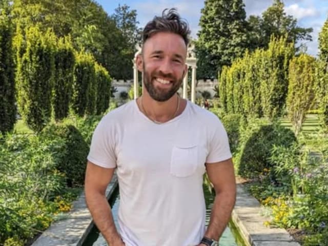 Tyler Wall, MrBeast's fitness coach, smiling in a garden before his tragic death from mitragynine toxicity linked to kratom overdose during a viral weight loss challenge—learn the true story, dangers of kratom, and how his legacy lives on through Pal Majd's emotional tribute.
